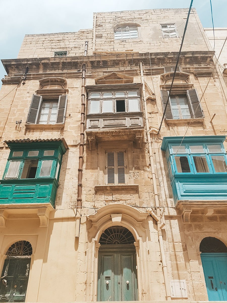Old building with blue and green windows and doors