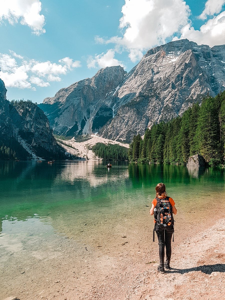 Backpacker standing in front of the lake