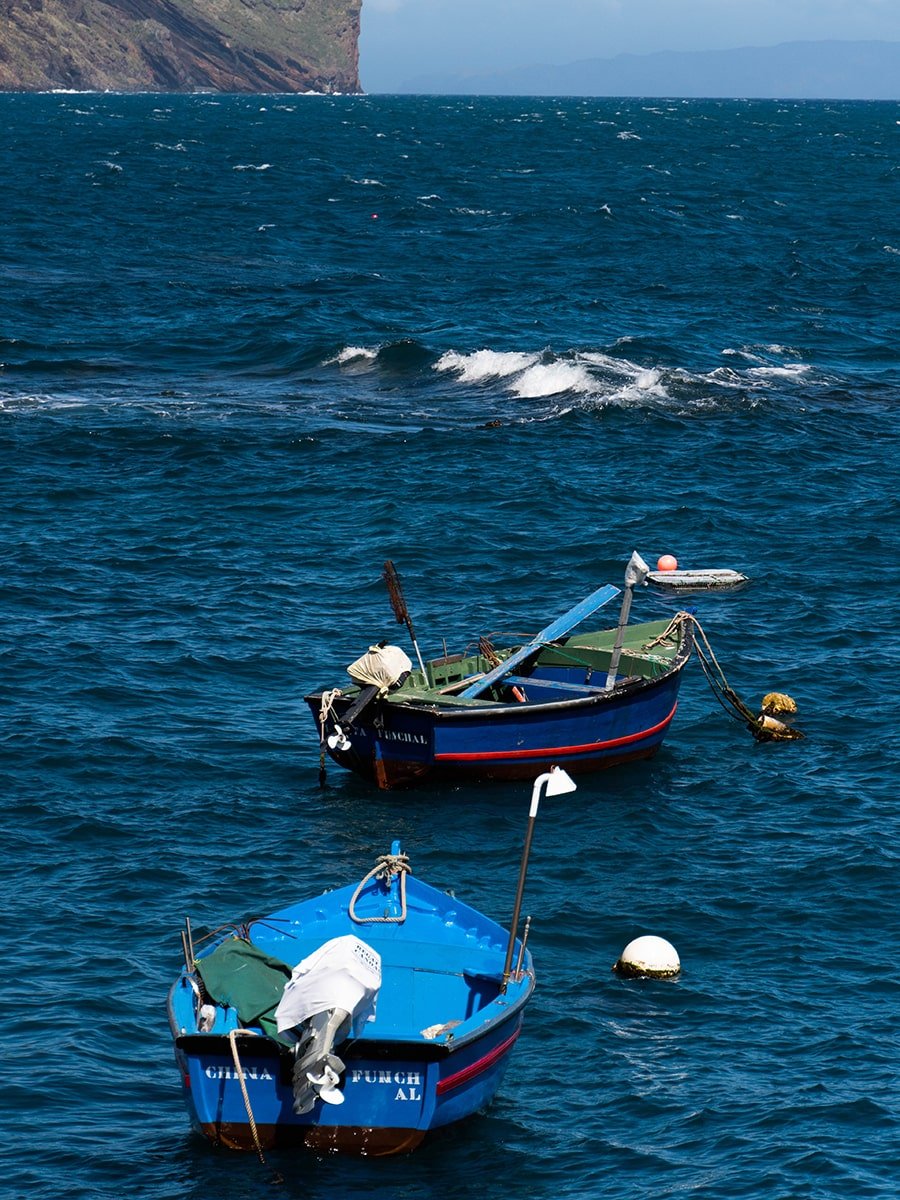 Two boats floating on the Atlantic Ocean