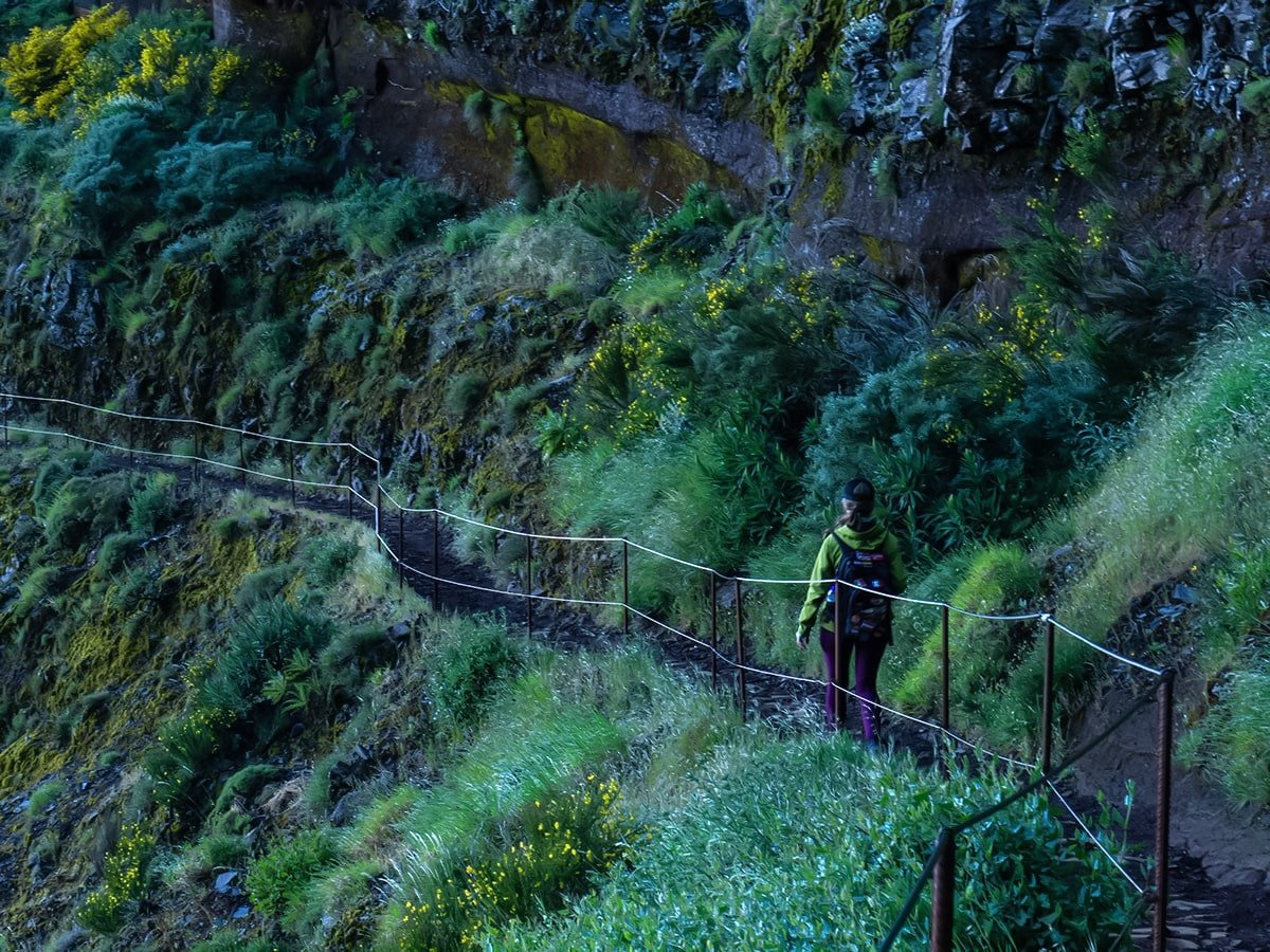 Backpacker hiking on the Pico Ruivo trail close to mountains