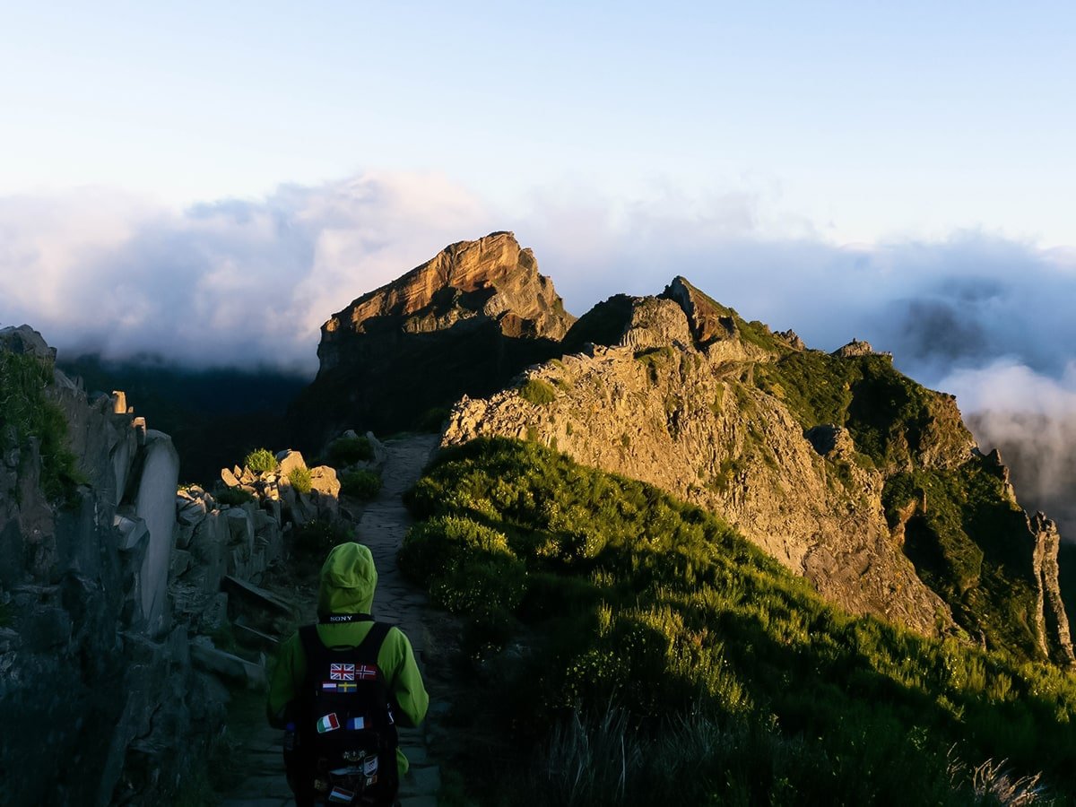 Backpacker on the Pico Ruivo trail at sunrise