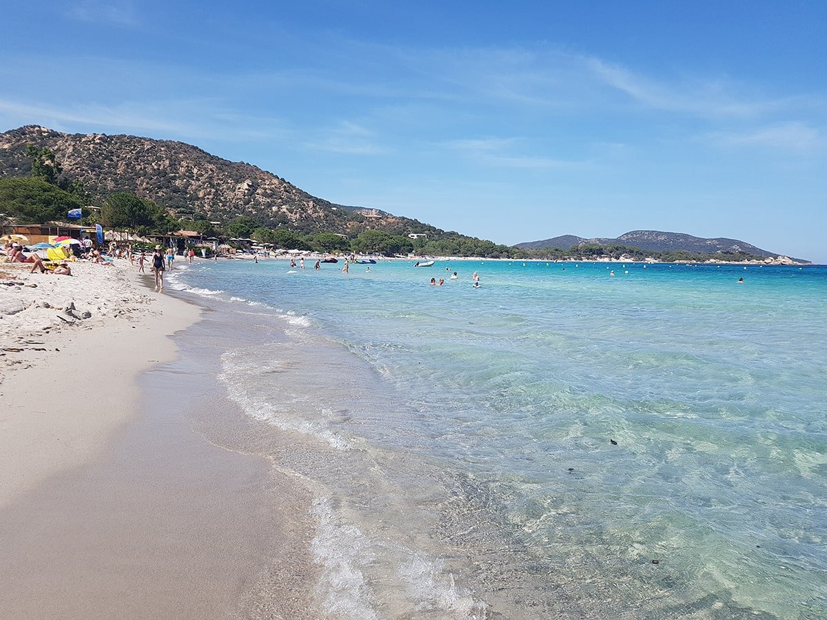 5 Stunning Corsican Beaches - Palombaggia: A postcard-perfect beach with turquoise waters, white sand, and stunning mountain views.