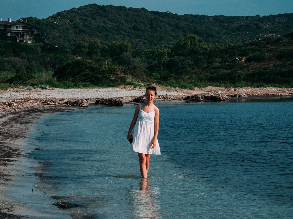 Walking in a white dress at the shore