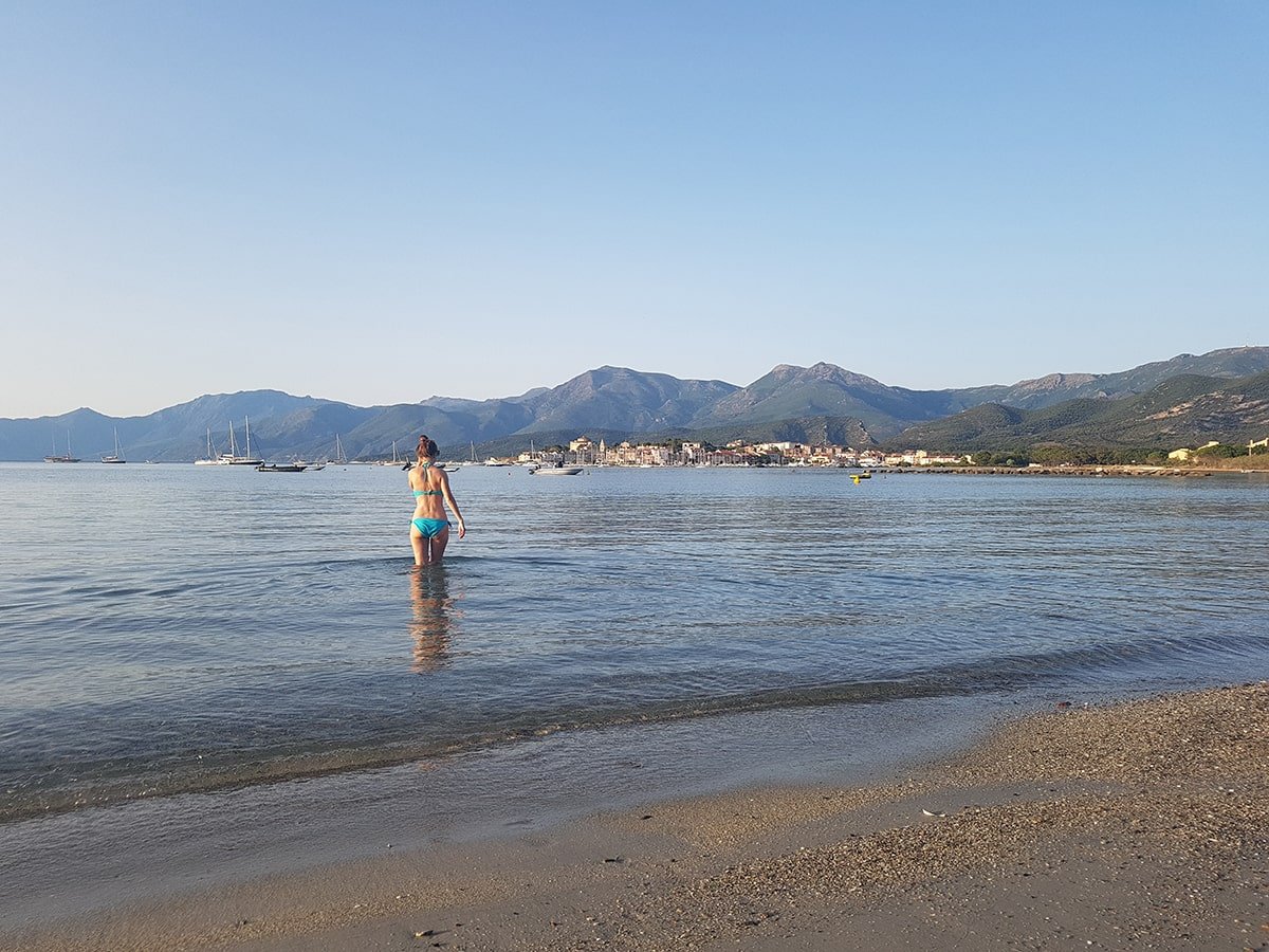 5 Stunning Corsican Beaches - St. Florent: A popular beach with azure waters, a long sandy shore, and charming seaside town nearby.