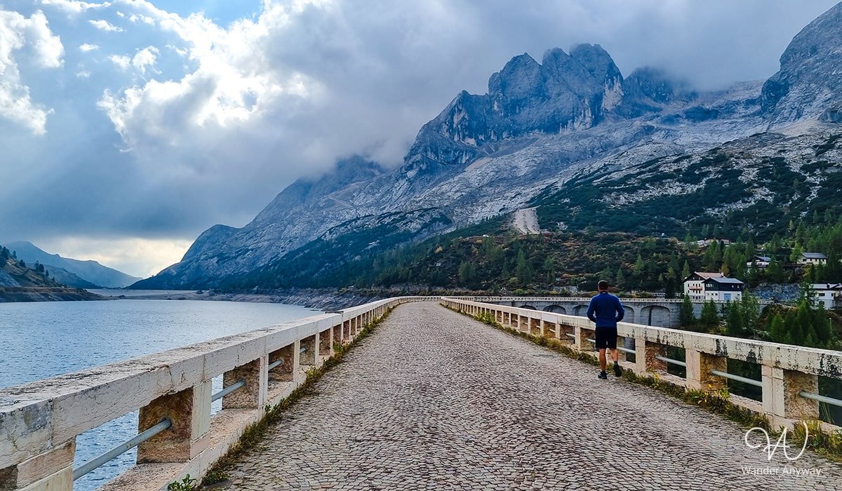 Lake Fedaia Tranquility: A serene alpine lake surrounded by the majestic peaks of the Dolomites.