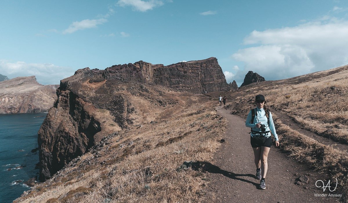 A hiker enjoying the panoramic vistas along the PR8 trail at Ponta de São Lourenço