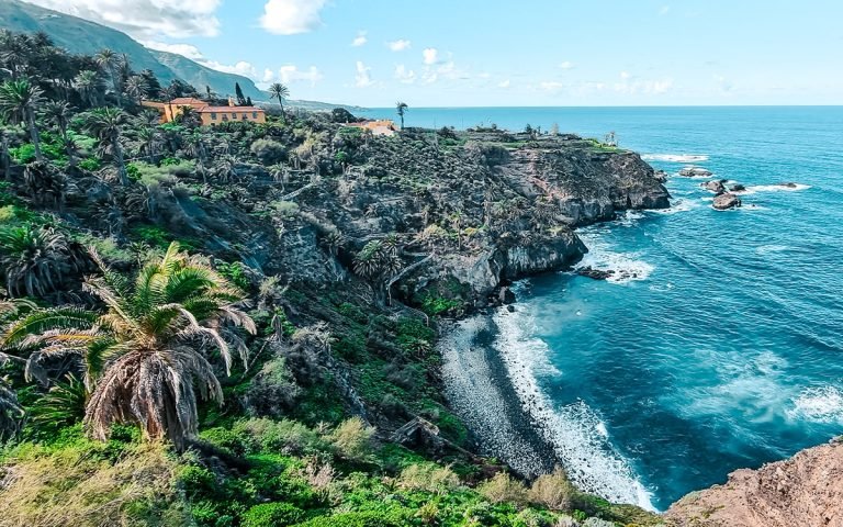 Pebble beach surrounded by cliffs and palm trees from Best beaches in Tenerife (northwest and south)