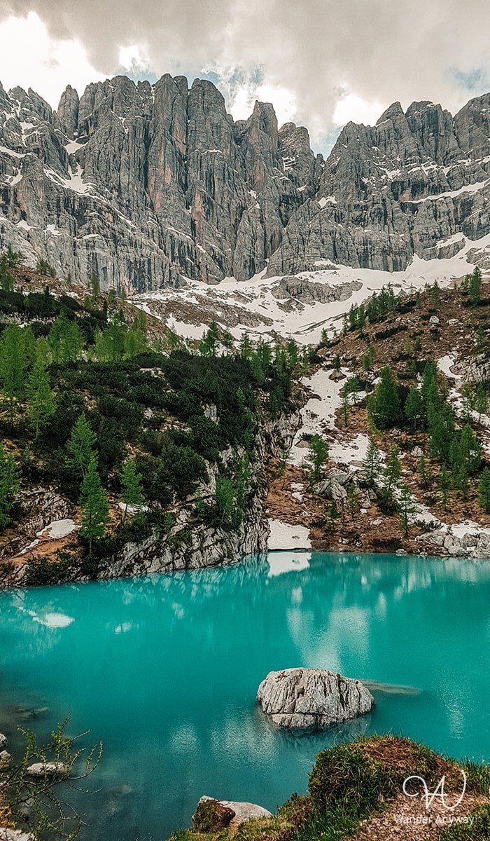 Crystal-clear waters of Lake Sorapis surrounded by rugged peaks