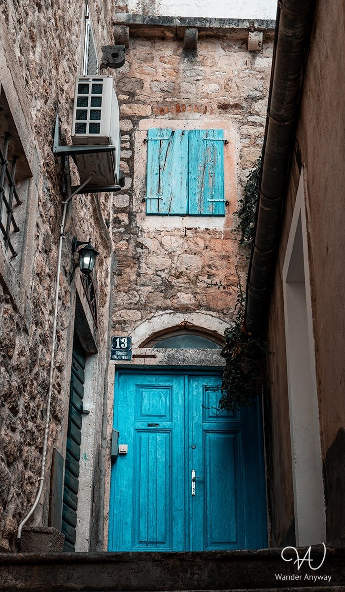 Quaint stone house adorned with charming blue windows and door