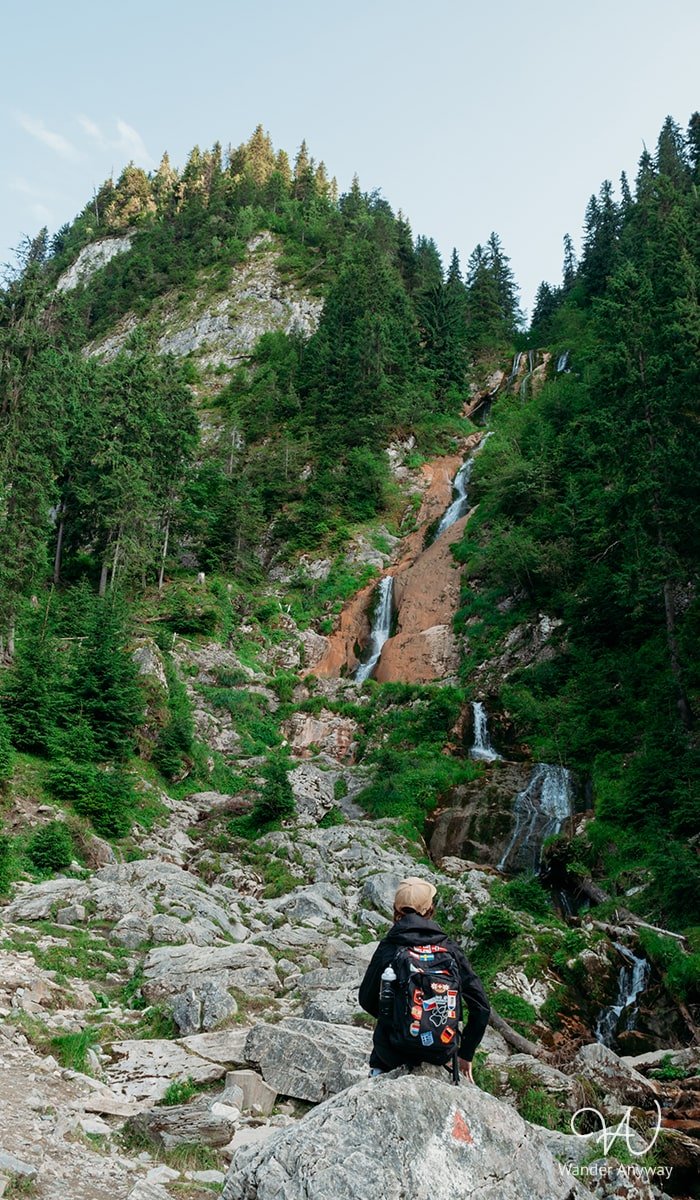 Horses' Waterfall in the Rodnei Mountains with hikers in the foreground
