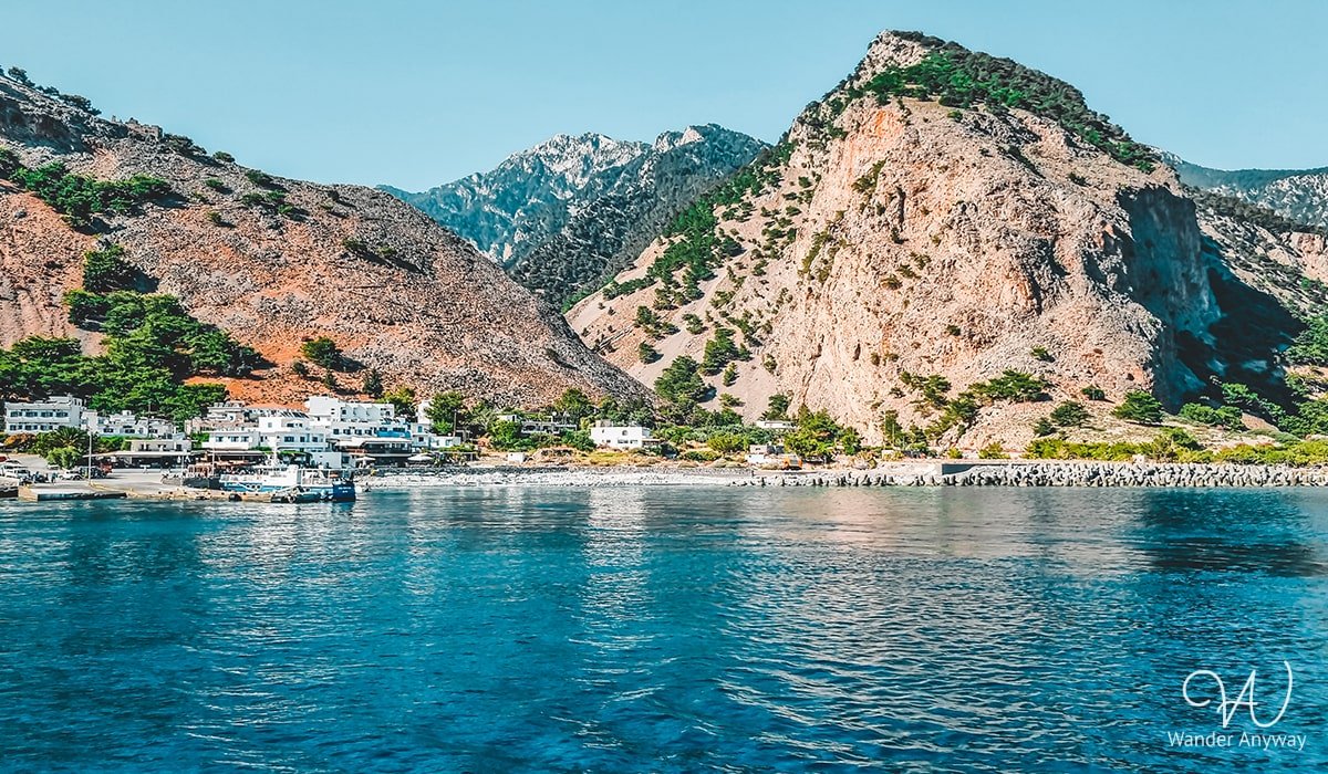 Picturesque Agia Roumeli Beach with clear waters and a serene backdrop after hiking Samaria Gorge.