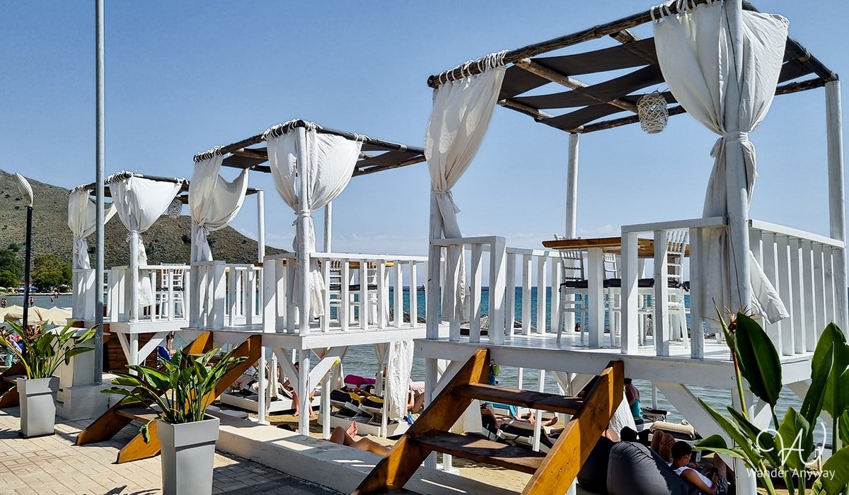 Georgioupoli Beach with golden sand and shallow waters, offering a serene family-friendly environment.