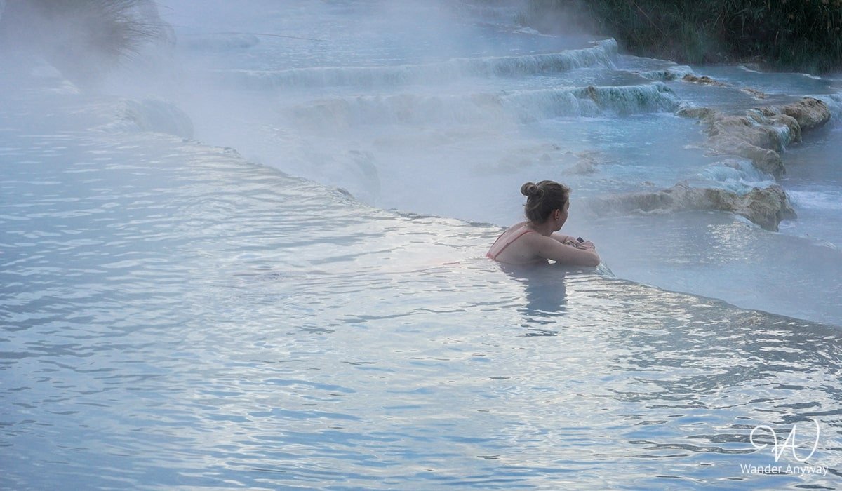 Natural limestone pools at Cascate del Mulino thermal springs, offering relaxation in Tuscany’s countryside