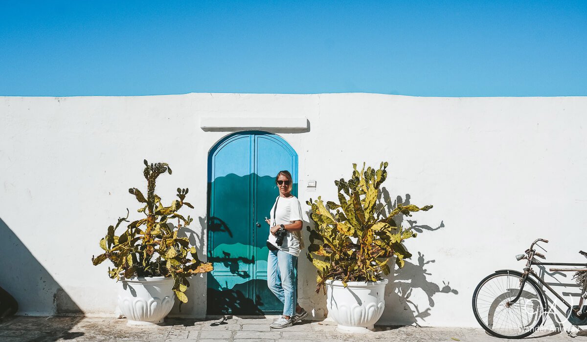 Vibrant painted door tucked away in a narrow alley in Ostuni, a photo-worthy stop on the way from Bari to Ostuni