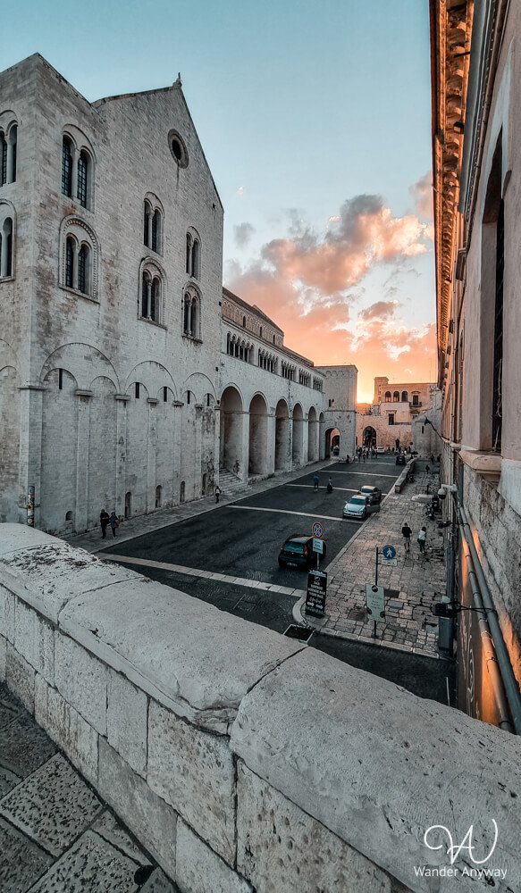 Lush green moat and towers of the Swabian Castle in Bari, an easy-to-reach site during a Puglia itinerary without a car.