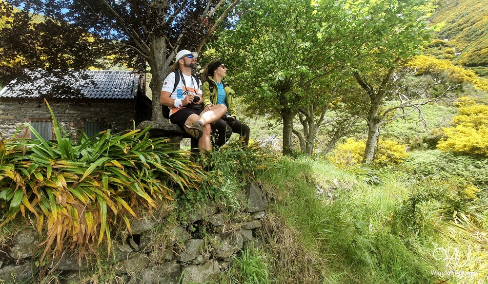 Hikers resting under tree shade near Rabaçal trail