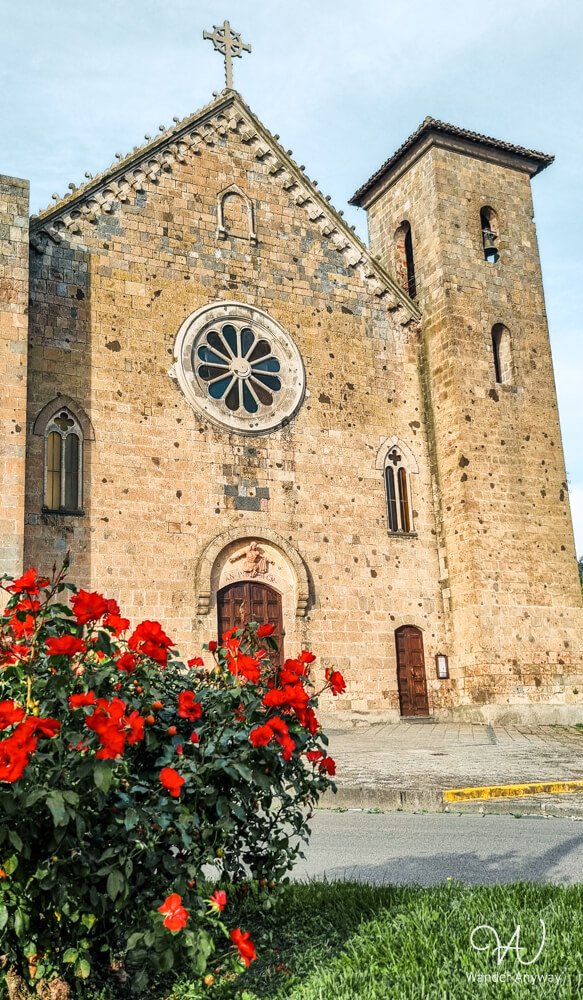 Exterior of Basilica of Santa Cristina with red flowers